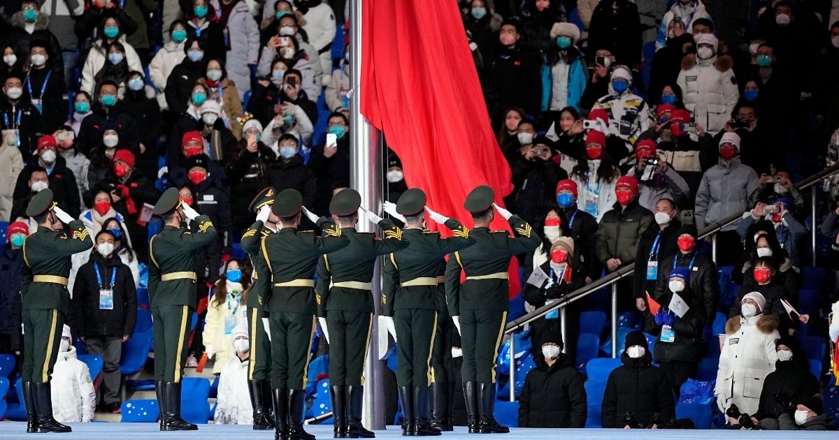 Members of the Chinese military stand at attention as the Chinese flag is raised during the Opening Ceremony of the Beijing Winter Olympics on Friday.