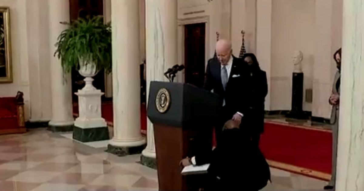An aide steps in to help President Joe Biden as he fumbles with the podium after announcing his Supreme Court nominee. Biden then remarked, 'See, presidents can't do much.'