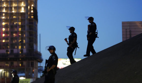 Police officers keep watch as demonstrators gather in downtown Austin, Texas, on June 4, 2020, as they protest the death of George Floyd. The Travis County district attorney is indicting 19 police officers on charges of excessive force against protesters in May of 2020.
