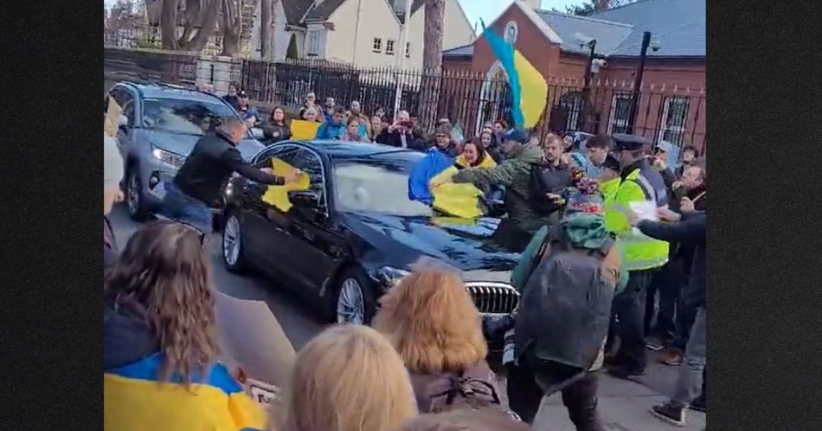 Protesters in Ireland mob the Russian ambassador's vehicle with Ukranian flags as it attempts to pass.