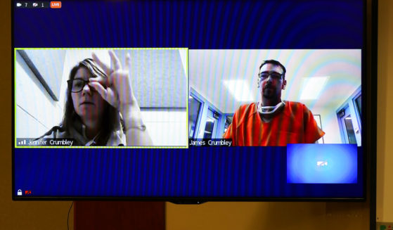 An screen capture shows Jennifer Crumbley signing a message to her husband James during a Jan. 7 Zoom conference court hearing in Rochester Hills, Michigan. The couple's son is charged with killing four students during a shooting at Oxford High School on Nov. 30. The boy's mother and father are charged in connection with allowing him access to the weapon.