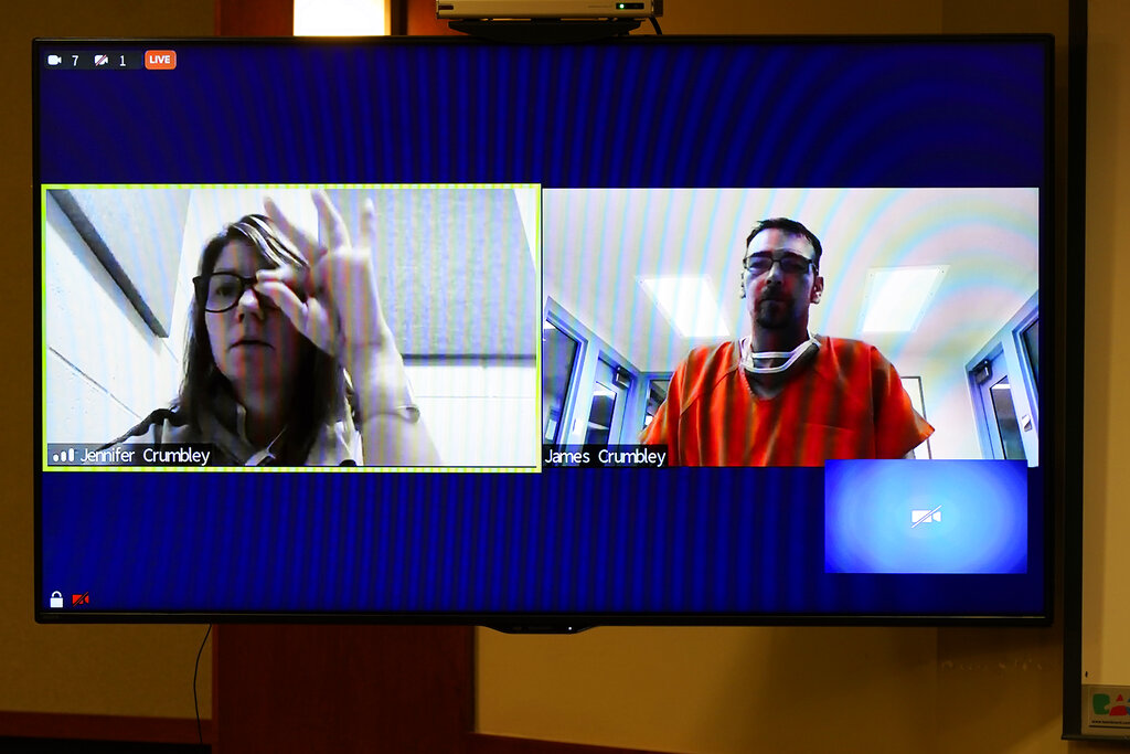 An screen capture shows Jennifer Crumbley signing a message to her husband James during a Jan. 7 Zoom conference court hearing in Rochester Hills, Michigan. The couple's son is charged with killing four students during a shooting at Oxford High School on Nov. 30. The boy's mother and father are charged in connection with allowing him access to the weapon.