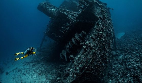 In this stock photo, a scuba diver swims nears a shipwreck in the Red Sea.