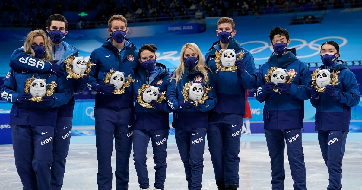 The American figure skating team, consisting of nine athletes, takes a group photo after winning the silver medal for the team event on Feb. 7 at the 2022 Beijing Winter Olympics.