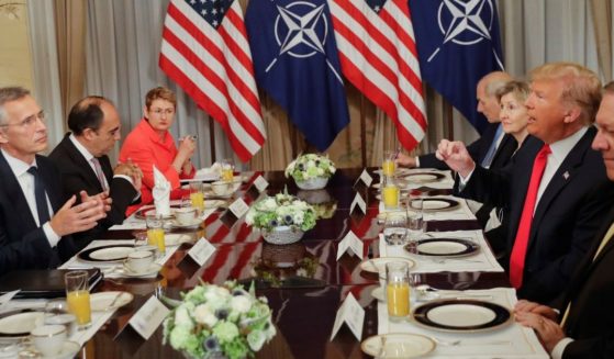 President Donald Trump, right, makes a point in a conversation with NATO Secretary General Jens Stoltenberg, left, during their bilateral breakfast in Brussels on July 11, 2018.