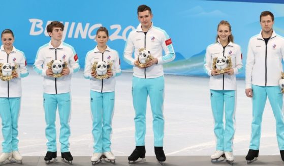 Russian skaters Kamila Valieva, Anastasia Mishina, Aleksandr Galliamov, Victoria Sanitsina, Nikita Katsalapov and Mark Kondratiuk are seen at a Feb. 7 ceremony during the Beijing 2022 Winter Olympic Games. The medal ceremony has been delayed after a Russian skater failed a drug test, leaving the official outcome of the competitions up in the air.