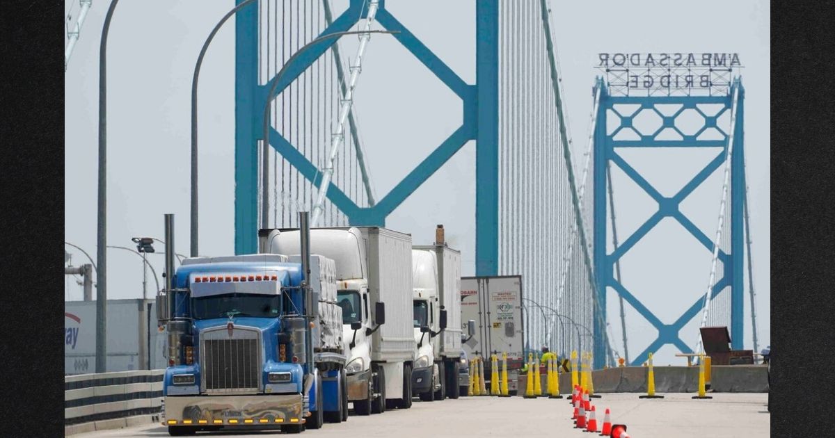 Commercial trucks enter the United States from Canada at the Ambassador Bridge in Detroit in this file photo from August 2021. Canada's 'Freedom Convoy' has spread to the area, with a line of trucks blocking traffic since Monday in protest of vaccine mandates.