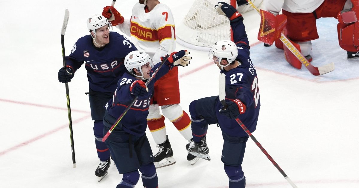 Team USA's Noah Cates, right, celebrates with teammates after scoring a goal against host China in the Winter Olympics at the National Indoor Stadium in Beijing on Thursday.