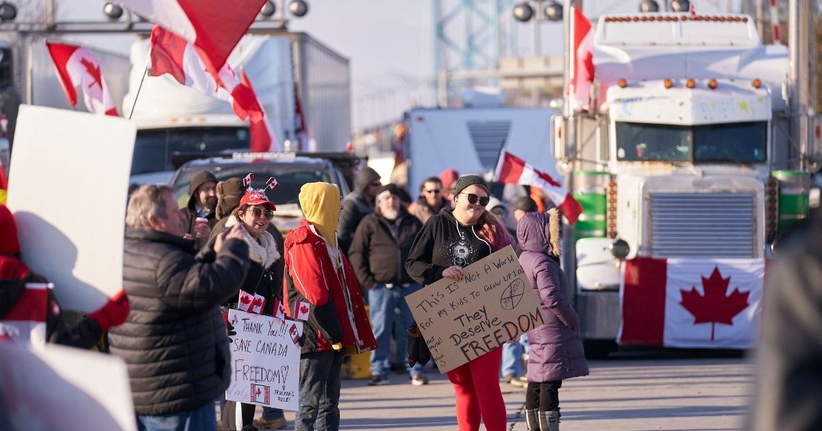 Protesters against Covid-19 vaccine mandates block the road Tuesday at the Ambassador Bridge that connects Detroit to Windsor, Canada.