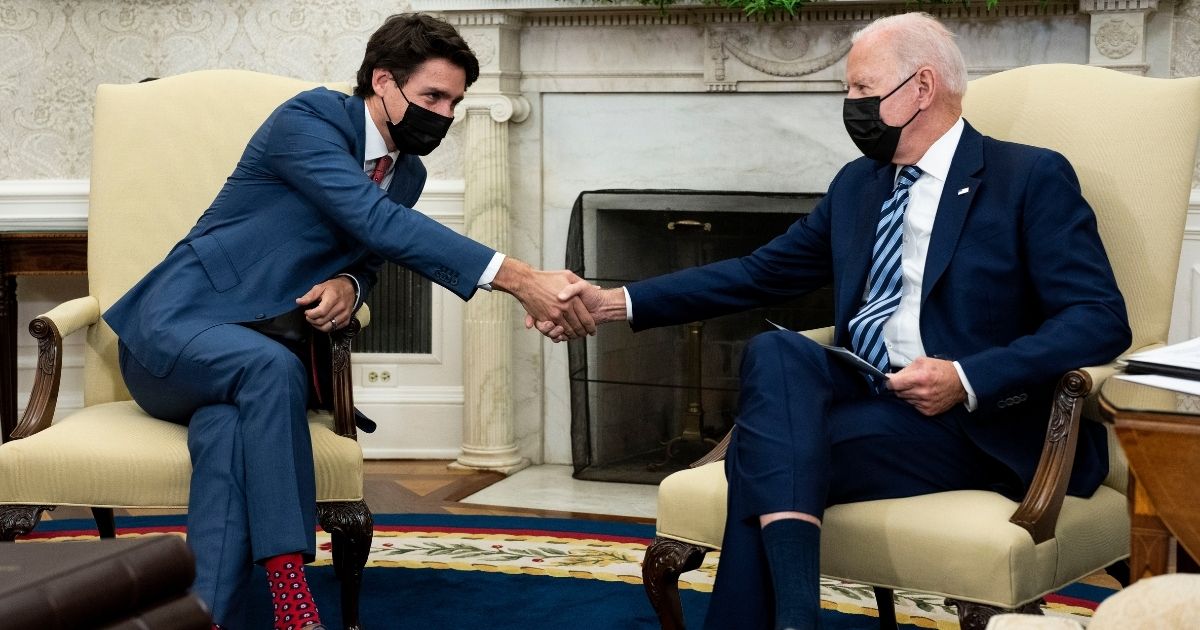 President Joe Biden shakes hands with Canadian Prime Minister Justin Trudeau during a meeting in the Oval Office of the White House on Nov. 18, 2021.