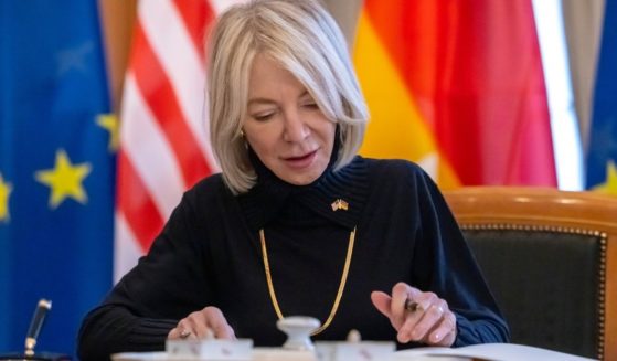 Amy Gutmann, the Biden administration's ambassador to Germany, signs a guest book during her accreditation ceremony at the German president's residence in Berlin on Feb. 17.