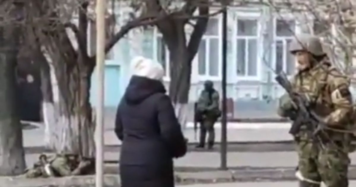 A Ukrainian woman confronts a Russian soldier in Henichesk, on the sea of Azov.