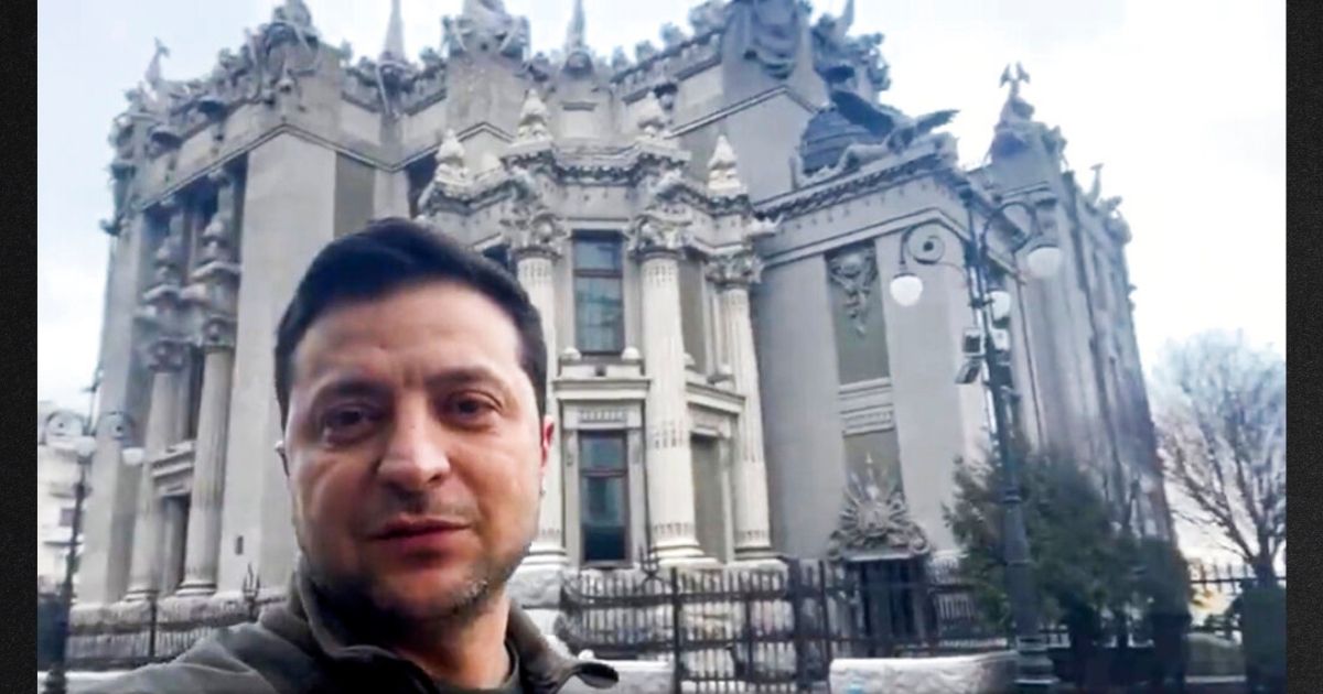 Ukraine President Volodymyr Zelenskyy speaks to the nation via his phone in the center of Kyiv, Ukraine, on Saturday. Zelenskyy refused an American offer to evacuate, saying, "The fight is here. I need ammunition, not a ride."