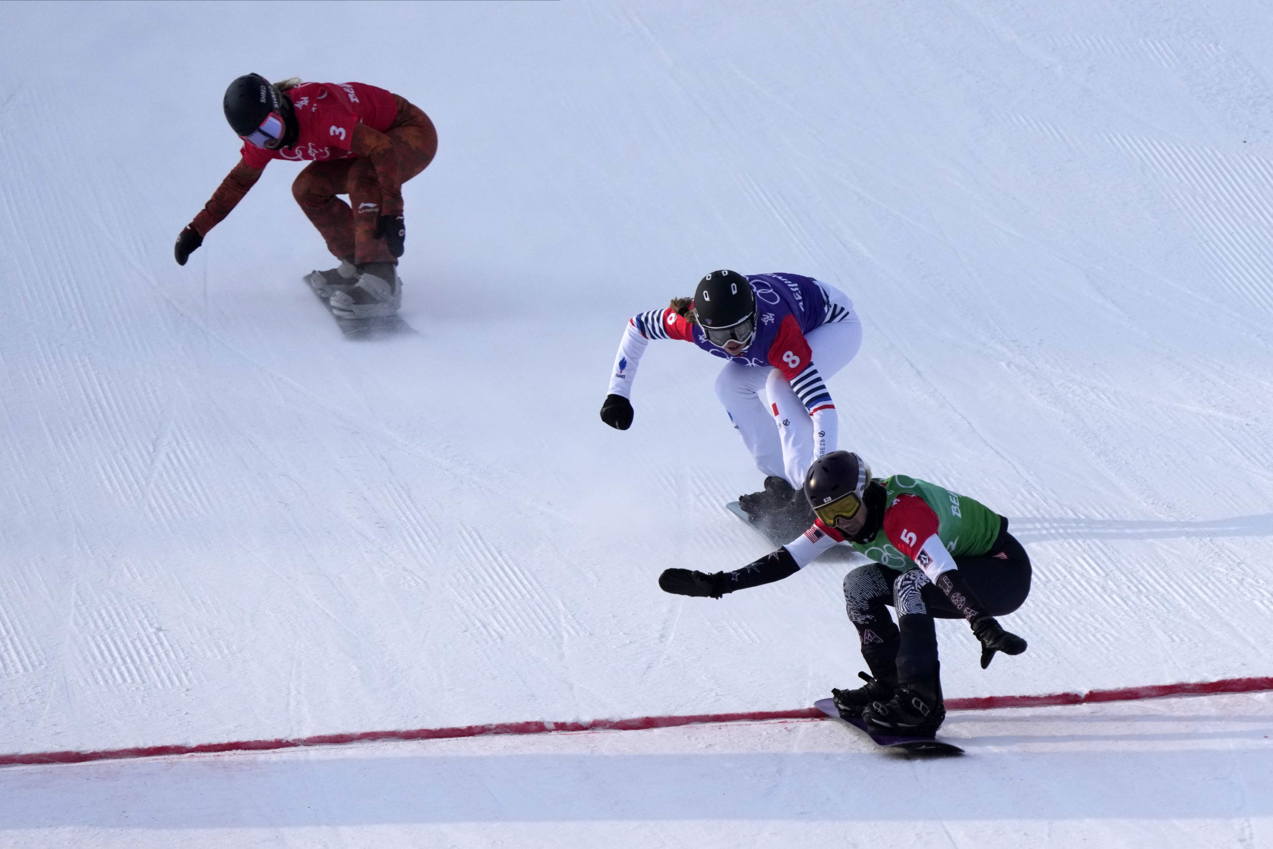 The United States' Lindsey Jacobellis (5) crosses the finish line to win the gold medal in snowboard cross Wednesday in Zhangjiakou, China, during the 2022 Winter Olympics.
