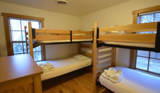 Cabin C at Kiptopeke State Park has a room full of bunk beds, similar to many rooms and cabins at children's camps.
