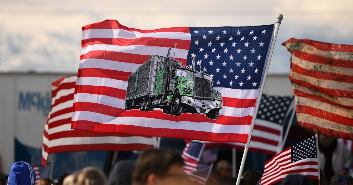 Supporters gather to rally with truckers at the start of 'The Peoples Convoy' protest against COVID-19 vaccine and mask mandates in Adelanto, Calif, on Wednesday. The convoy is expected to arrive in Washington on March 5.