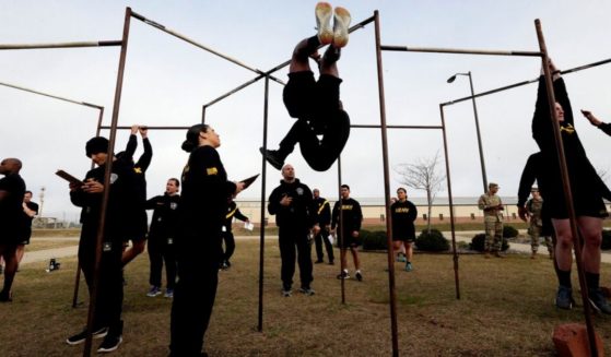 US Army troops participate in the Army combat fitness test at the 108th Air Defense Artillery Brigade compound at Fort Bragg, N.C. in this file photo from January 2019. After three years of complaints and debate, the Army has dumped plans to have a physical fitness test that is gender and age neutral, and will now allow women and older soldiers to pass with lower scores.