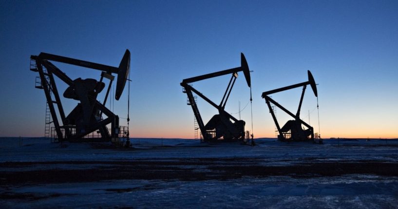 The silhouettes of pumpjacks are seen above oil wells in the Bakken formation in North Dakota.