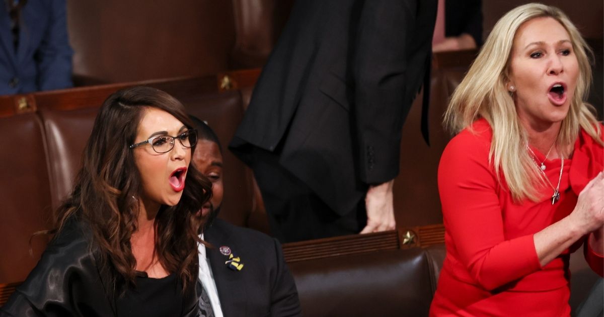 Republican Reps. Lauren Boebert of Colorado and Marjorie Taylor Greene of Georgia chant "Build the wall" after President Joe Biden mentioned the need to secure the border during his State of the Union address at the Capitol in Washington on Tuesday.