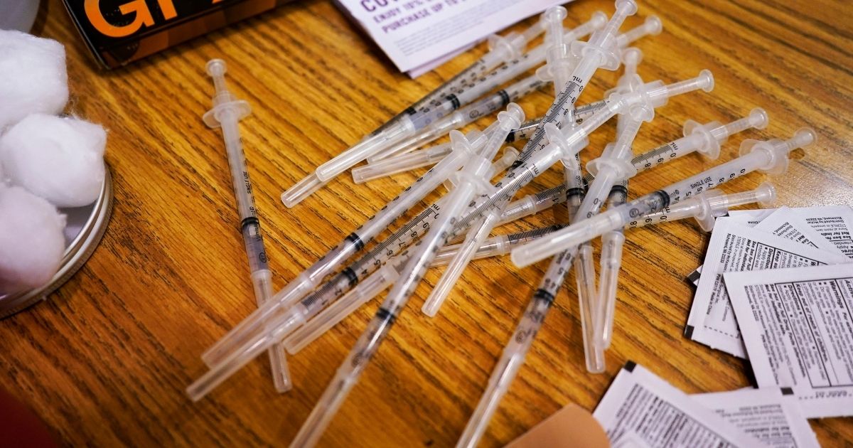 Prepared Pfizer COVID-19 vaccine syringes sit on a table before being administered to patients at a middle school in Wheeling, Illinois, on June 11, 2021.
