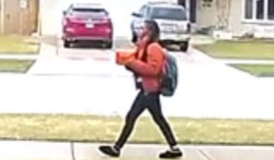 A female "posing as if she was selling candy" knocked on the woman's door as part of a home invasion on Tuesday, the Oak Lawn, Illinois, Police Department said in a news release.