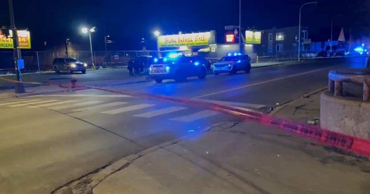 Chicago police work the scene where two officers were shot after stopping to get something to eat at the Original Maxwell Street around 3:30 a.m. Friday.