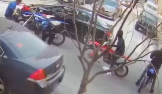 A group on dirt bikes and an ATV approached a vehicle and pulled the driver and passenger out of it before assaulting and robbing them at a Harlem intersection in New York City on Tuesday.
