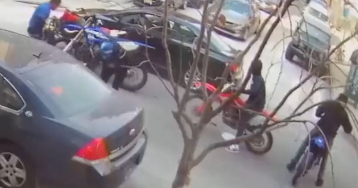 A group on dirt bikes and an ATV approached a vehicle and pulled the driver and passenger out of it before assaulting and robbing them at a Harlem intersection in New York City on Tuesday.