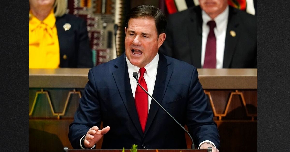Arizona Republican Gov. Doug Ducey, seen in a file photo from January, signed bills Wednesday to limit abortion and restrict sports competitors to playing based on their biological gender.