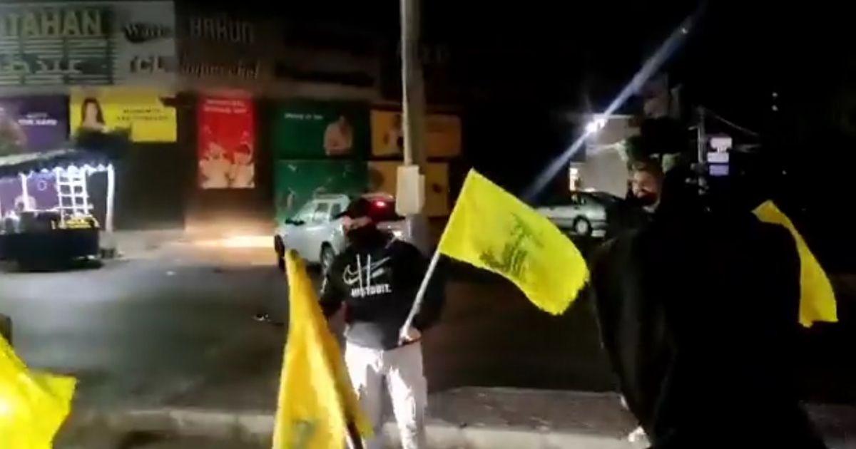 Hezbollah supporters hand out sweets to motorists in Beirut to celebrate a deadly terrorist attack.