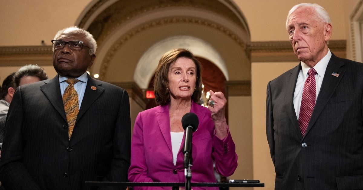 House Democrats, from left, Majority Whip James Clyburn of South Carolina, Speaker Nancy Pelosi of California and Majority Leader Rep. Steny Hoyer of Maryland speak to reporters on their way to the House Chamber at the U.S. Capitol in Washington on Nov. 5.