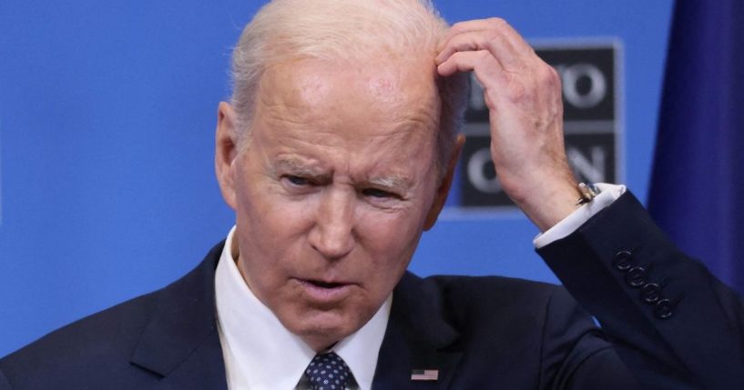 President Joe Biden scratches his head during a news conference at NATO headquarters in Brussels on Thursday.