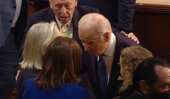 President Joe Biden moves in to slowly headbutt a woman, identified as California Rep. Jackie Speier, after his State of the Union address on Tuesday.