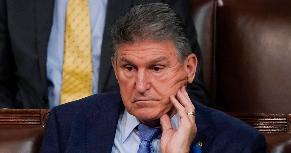 Democratic Sen. Joe Manchin of West Virginia listens to President Joe Biden's State of the Union address in the chamber of the House of Representatives on Tuesday.