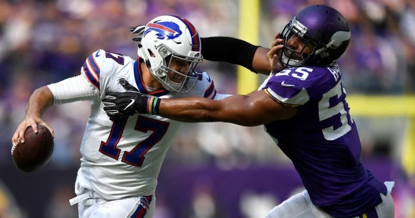 Josh Allen of the Buffalo Bills stiff arms defender Anthony Barr of the Minnesota Vikings during a game at U.S. Bank Stadium in Minneapolis on Sept. 23, 2018. Barr was penalized on the play for a horse-collar tackle.