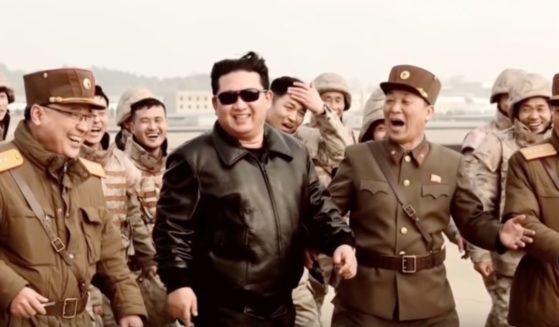 In a propaganda video released Thursday, North Korean leader Kim Jong Un, center, is seen smiling and laughing with military personnel after an alleged successful launch of an intercontinental ballistic missile.