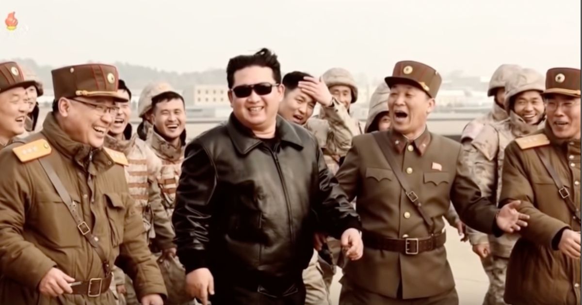 In a propaganda video released Thursday, North Korean leader Kim Jong Un, center, is seen smiling and laughing with military personnel after an alleged successful launch of an intercontinental ballistic missile.