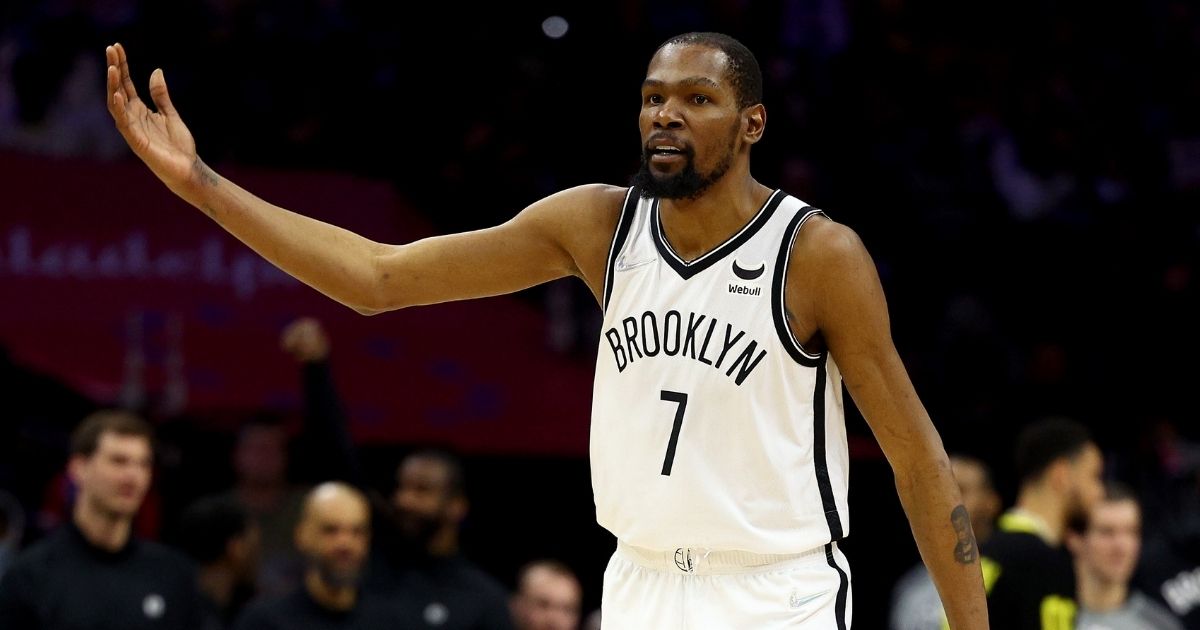 Kevin Durant of the Brooklyn Nets encourages the crowd to keep booing during a game against the Philadelphia 76ers at Wells Fargo Center on Thursday