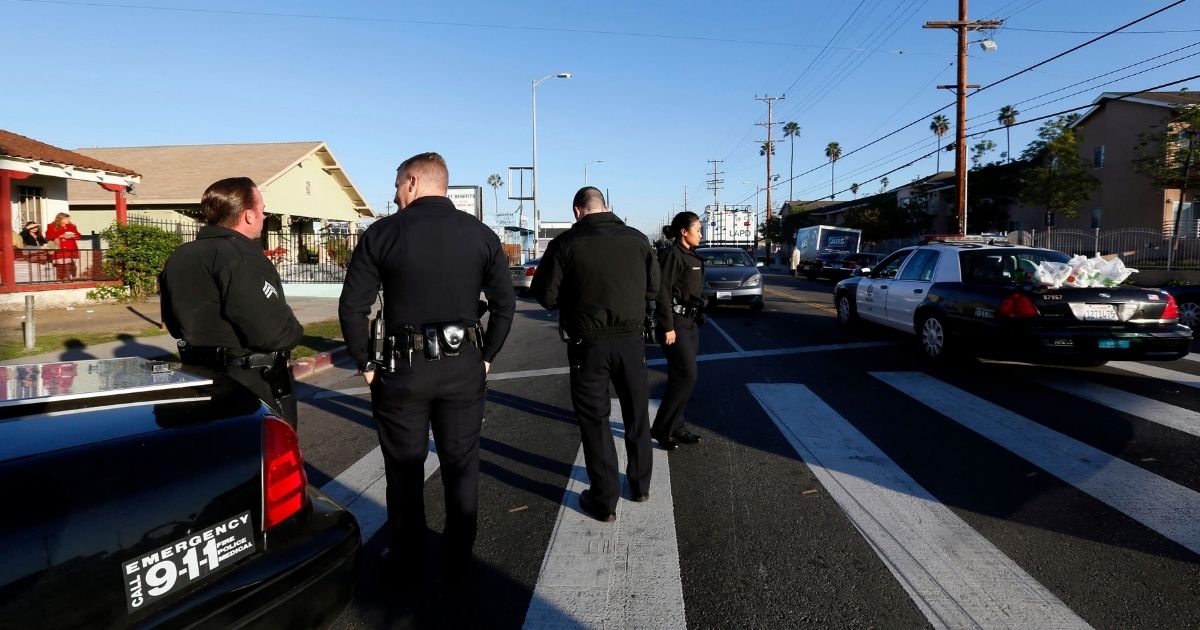Officers with the Los Angeles Police Department investigate a shooting in South Central Los Angles on Dec. 29, 2014.