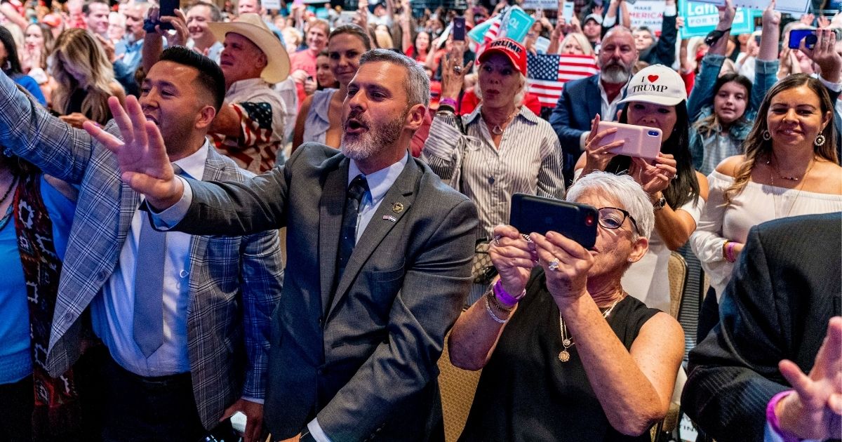 A group of supporters cheered for then-President Donald Trump as he spoke at a Latinos for Trump Coalition roundtable in Phoenix, Arizona, on Sept. 14, 2020.