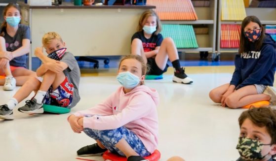 Fifth-graders wear face masks during a music class at Milton Elementary School in Rye, New York, on May 18, 2021.