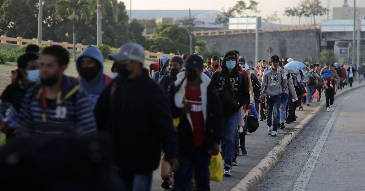 Migrants intending to reach the United States walk in a caravan in San Pedro Sula, Honduras, on Jan. 15.