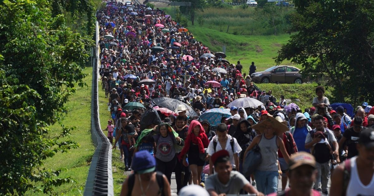 On Oct. 27, 2021, migrants walked through Villa Comaltitlan, Chiapas state, Mexico, on their way to the Mexico-U.S. border.