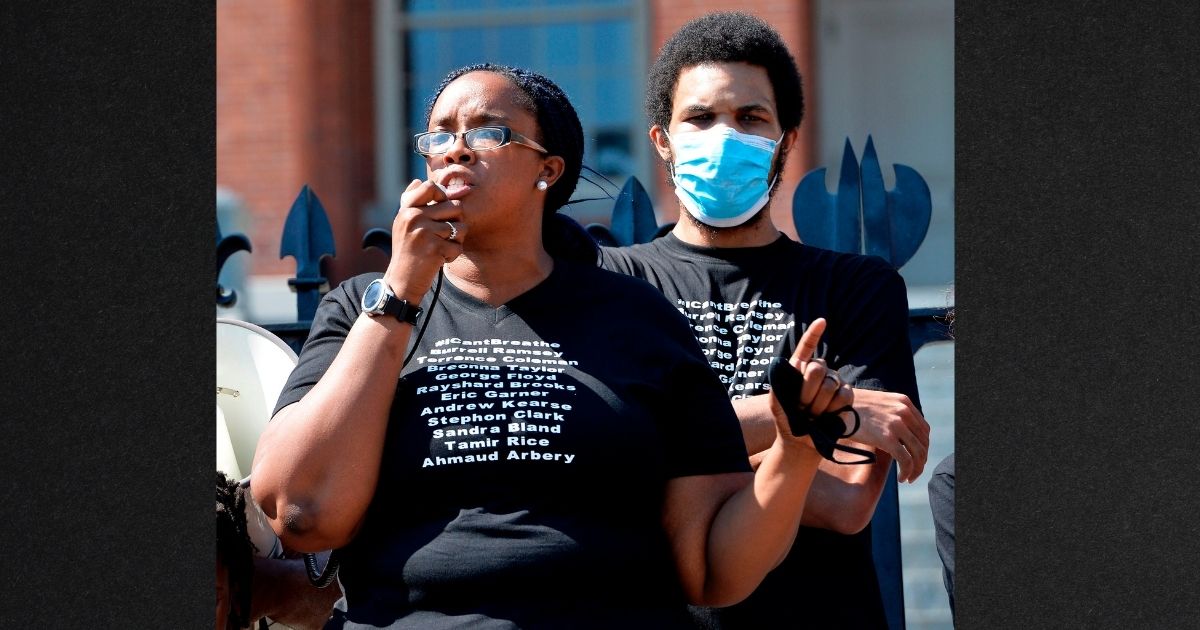 Monica Cannon-Grant speaks to a crowd during a protest in Boston, Mass,. in this file photo from June 2020. Cannon-Grant and her husband have been indicted on multiple fraud charges in connection with alleged misuse of donations to an anti-violence charity, reportedly spending the money on expensive hotels, travel, lavish meals and nail salon visits.