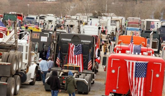 Trucks taking part in the "People's Convoy" are parked at the Hagerstown Speedway in Hagerstown, Maryland, on Saturday, as the convoy plans to head into the Washington, D.C., area.