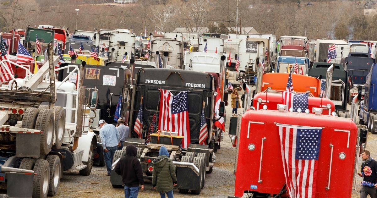 Trucks taking part in the "People's Convoy" are parked at the Hagerstown Speedway in Hagerstown, Maryland, on Saturday, as the convoy plans to head into the Washington, D.C., area.