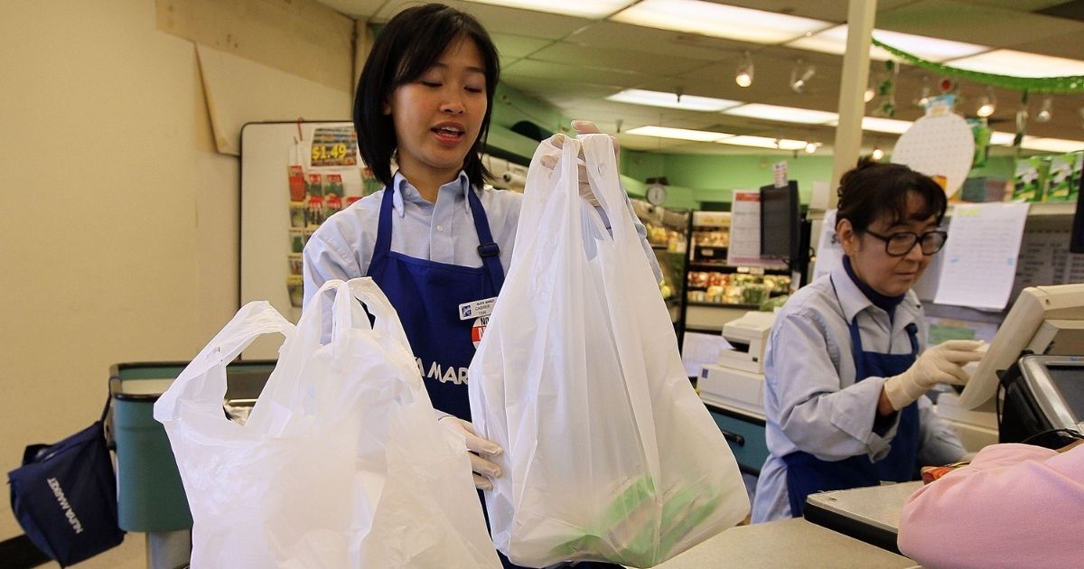 A cashier places groceries in plastic bags at Nijiya Market in San Francisco on June 2, 2010.