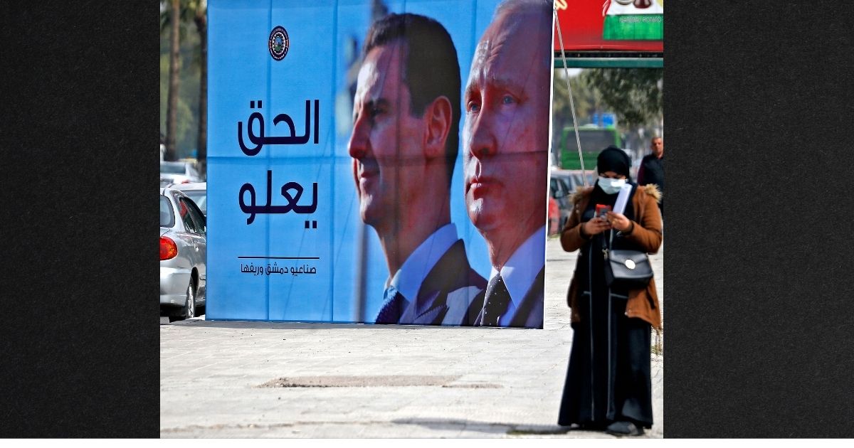 A banner depicting Syrian President Bashar al-Assad and Russian President Vladimir Putin and reading 'Justice Prevails' is displayed along a highway in the Syrian capital Damascus, on March 8. The Russian government claims Syrians are volunteering to come fight as Russia struggles in its invasion of Ukraine.