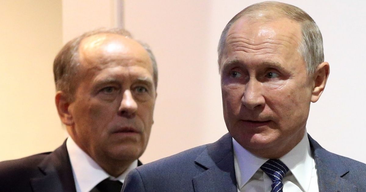 Russian President Vladimir Putin, right, is seen in a 2019 photo with Federal Security Service Chief Alexander Bortnikov. Putin may stop letting Bortnikov stand so close behind him if he gets wind of reports circulating that the FSB and other organizations may be plotting against him.