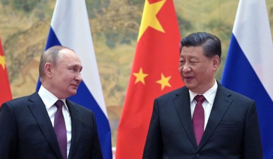 Russian President Vladimir Putin, left, and Chinese President Xi Jinping pose for a photograph during their meeting in Beijing on Feb.4. Anonymous officials have said China asked Russia to postpone the invasion of Ukraine until after the Olympics were over Feb. 20.